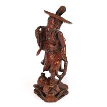 A mid 20th century Chinese caved hardwood figure of a fisherman, H. 30cm.