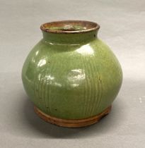 A large green glazed clay pot, possibly Korean, H. 21cm.
