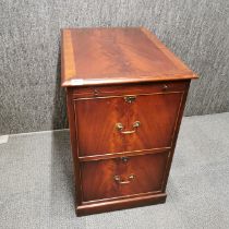 A two drawer flame and cross banded mahogany filing cabinet with pull out shelf 80 x 67 x 50cm.