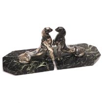 A pair of Art Deco patinated spelter bookends of sea lions on marble bases by Maurice Frecourt, c.