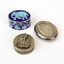 Three white metal pill boxes. Widest 4 cms.