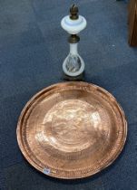 A large Eastern copper tray, dia. 70cm, with a 19th century opaline glass oil lamp.