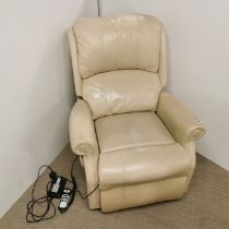 An electric adjustable beige faux leather armchair.