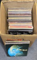 A large box of mixed rock, pop and chart LP records.