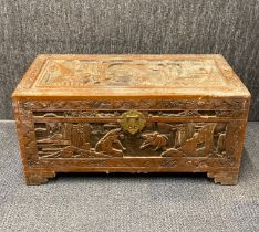 A Chinese carved camphor lined trunk, 79 x 38 x 38cm.