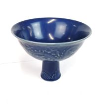 A Chinese blue glazed relief decorated stem bowl, dia. 14.5cm, H. 10.5cm.