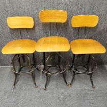 Three vintage adjustable Toledo bar stools/ draftmen's chairs.