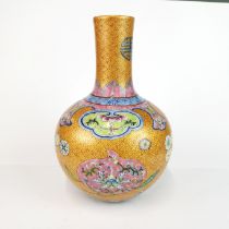 A finely decorated Chinese hand enamelled porcelain vase with famille rose colours, H. 26cm.