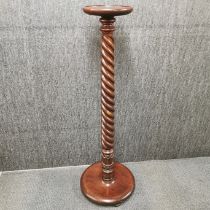 A carved and turned oak torchere stand, H. 135cm.