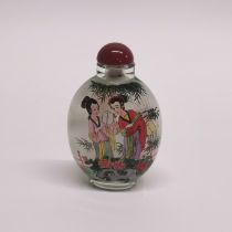 A signed Chinese inside painted snuff bottle with polished carnelian stopper, H. 9cm.