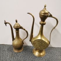 Two Eastern brass coffee pots, tallest H. 36cm.