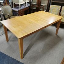 A large extending light oak dining table, 185 x 105cm (not extended).