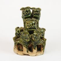 A small Chinese green glazed pottery figure of a liondog with six pups, H. 6.5cm.