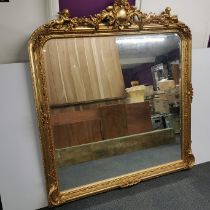 A very heavy gilt wood and gesso wall mirror with cherub decoration, 170 x 150cm.