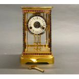 A gilt brass, enamelled and glass cased clock, 29 x 17 x 14cm.