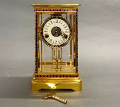 A gilt brass, enamelled and glass cased clock, 29 x 17 x 14cm.