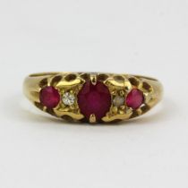 A hallmarked 18ct yellow gold diamond and ruby set ring, (R ). One replacement stone.
