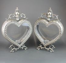 A pair of unusual heart shaped silvered metal and glass storm lanterns, H. 53cm.