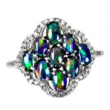 A 925 silver ring set with cabochon cut black opals and white stones, (P).