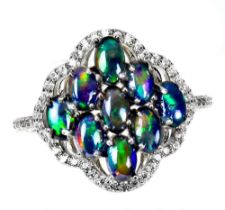 A 925 silver ring set with cabochon cut black opals and white stones, (P).