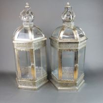 A pair of silvered metal and glass garden lanterns, H. 62cm.