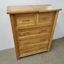 An oak chest of drawers with metal handles, 110 x 90 x 45cm.