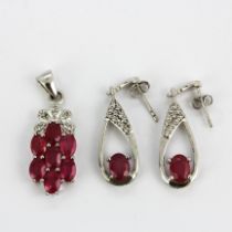 A 925 silver pendant set with oval cut rubies and white topaz, L. 3.5cm, together with a similar