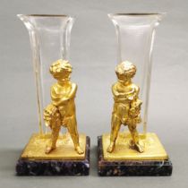 A pair of glass stem vases with gilt brass cherub decoration after 'L. Kley' on fluorite bases.