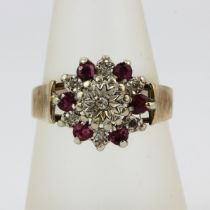 A hallmarked 9ct yellow gold ring set with round cut rubies and diamonds, (Q.5).