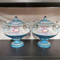 A pair of continental porcelain urns and covers, H. 25cm.