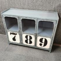 A numbered industrial style cabinet, with two cupboards and shelving inside. Printed numbers 7 8 9