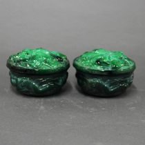 A pair of malachite glass boxes depicting naked female figures, dia. 9.5cm, D. 6cm.