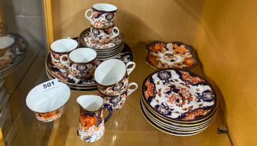 A Royal Crown Derby porcelain tea set with larger plates and small dish.