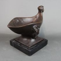 An unusual cast bronze bowl on a black marble base, W. 30cm, H. 24cm.