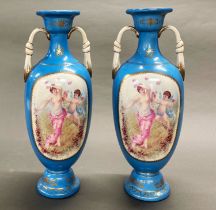 A pair of blue porcelain Sevres style vases, with cherub and gilt decoration, H. 44.5cm.