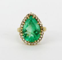 An 18ct yellow gold ring set with a large pear cut natural emerald, approx. 10ct, L. 1.8cm,