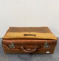 A vintage leather suitcase with canvas cover, 66 x 20 x 40cm.