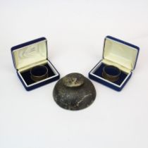 A pair of hallmarked silver napkin rings and a hallmarked silver inkwell. Inkwell diameter 10 cms.