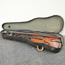 A cased antique violin, label inside reads Medio-fino.