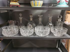 A quantity of cut crystal decanters and fruit bowls.