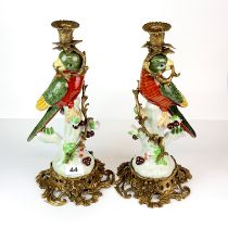 A fair of ormolu mounted porcelain parrot candlesticks, H. 36cm.