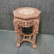 A Chinese carved hardwood octagonal plant stand with marble top and painted finish, H. 60cm W.