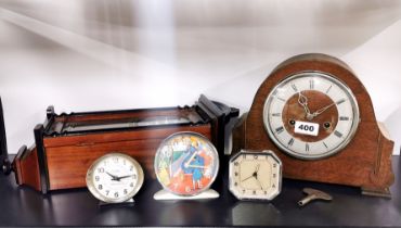 A group of five vintage clocks.