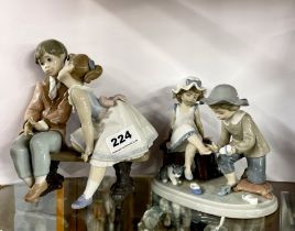 A Lladro 1995 10th anniversary figure of two children on a bench, H. 19cm. Together with a further