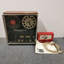 A vintage Sony reel-to-reel tape deck with a pair of headphones and instructions.