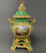 An early 19th C. soft paste porcelain jar cover and stand featuring Alnwick Castle, overall H. 44cm.