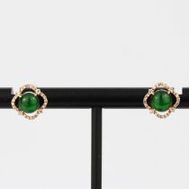 A pair of 18ct rose gold stud earrings set with cabochon jade surrounded by diamonds, L. 1cm.