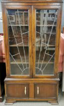 An Art Deco oak and glass display cabinet with two cupboard doors with interesting handles, 170 x 93
