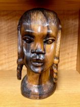 A large African carved figured ebony bust of a girl, H. 26cm.