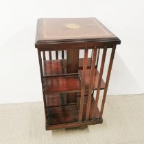 A cross banded and inlaid mahogany revolving bookcase, H. 85cm W. 47cm.